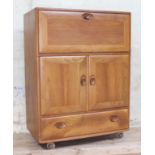 An Ercol elm bureau with visible dovetail joints, width 83cm, depth 45cm & height 110.5cm. Condition