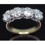 A four stone diamond ring, the four modern round brilliant cut stones weighing approx. 0.72, 0.68,