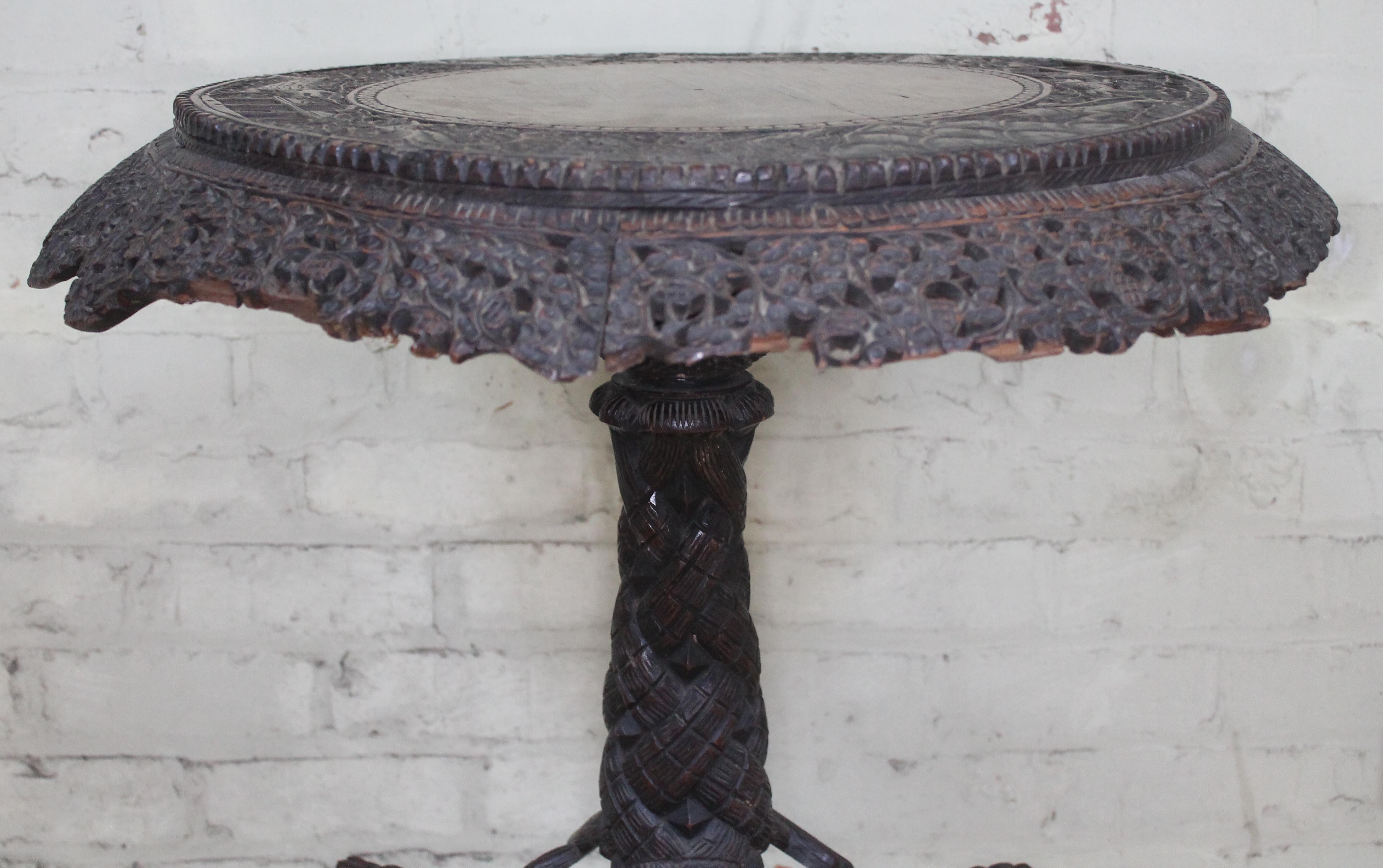 A 19th century Anglo-Indian rosewood tripod table with flip top and carved profusely with hunting - Image 4 of 6