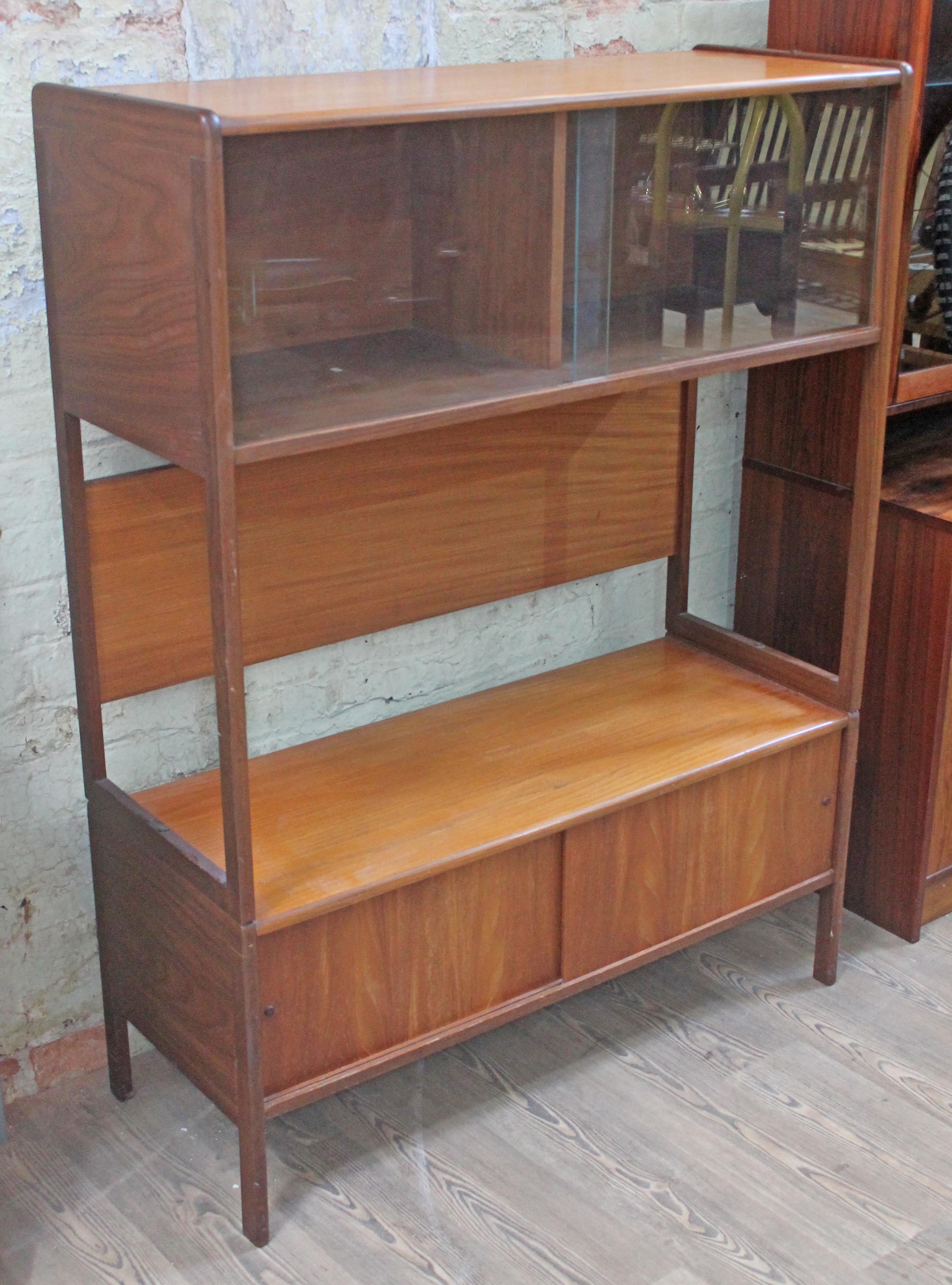 A retro 1960s room divider with glazed top section above open space and lower cabinet, width