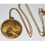 A French 18ct gold medallion decorated with birds and the reverse inscribed 'Ni vous sans moi ni moi