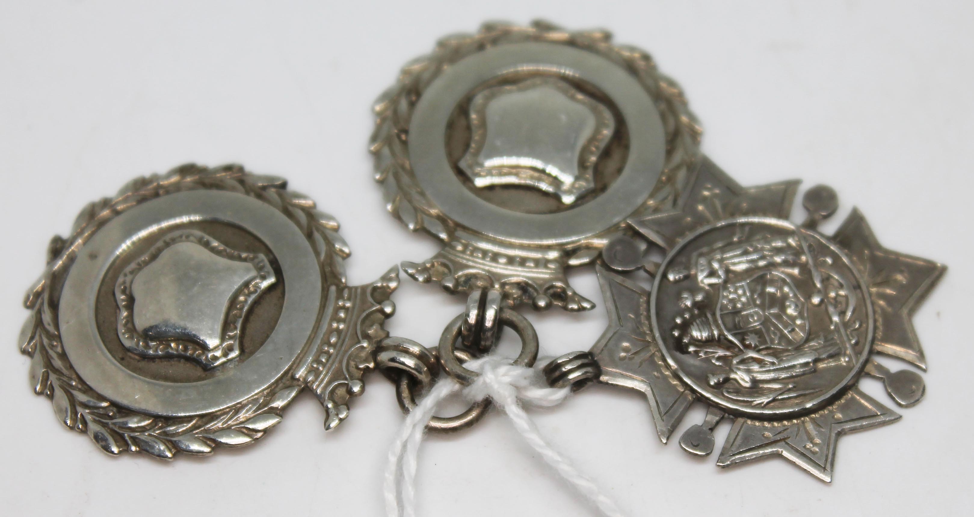 A group of three hallmarked silver fob medals, gross weight 23.5g.