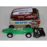 A mixed lot of toys comprising a green plastic Ferrari 678, a Chinese Mystery Action Bus, a wooden