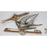 A 9ct gold bar brooch, a white metal swallow brooch and another, gross wt. 8.38g.