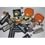 A box of bric a brac including buttons, military badges etc.