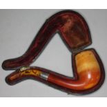 A meerschuam pipe with white metal colar and pressed butterscotch amber mouthpiece and velvet