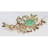 A hallmarked 9ct gold brooch set with a green cabochon, length 4.2cm, gross weight 4.2g.