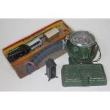An Astra search light, a lead sentry box and a 1950s clockwork train set.