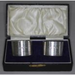 A cased pair of hallmarked silver serviette rings.