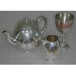 Elkington & Co silver plate comprising a two piece part tea service and a goblet.