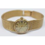 A ladies 9ct gold Omega automatic wristwatch with gold tone signed dial, black and gold hour markers