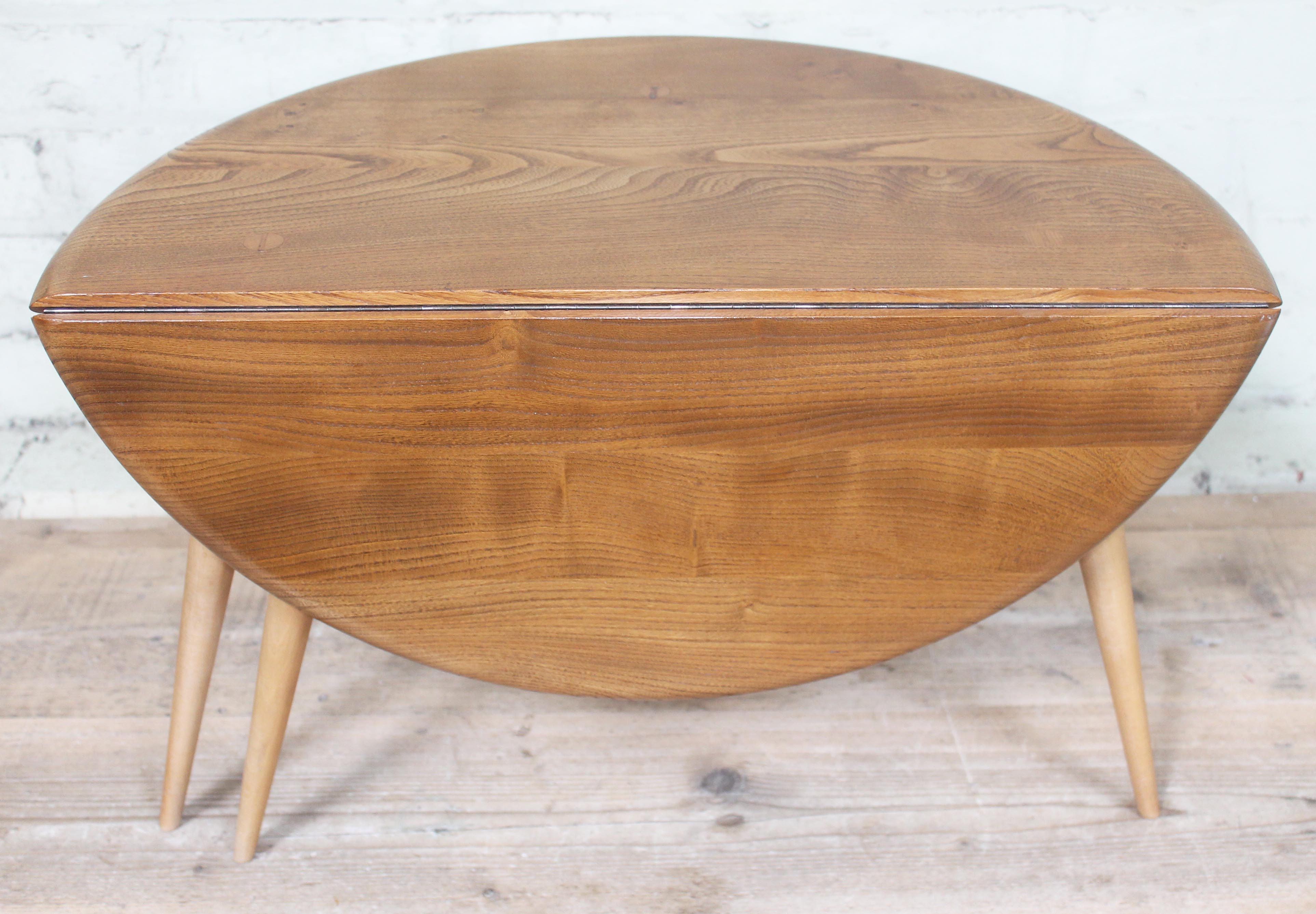 An Ercol blonde elm and beech occasional coffee table with drop leaf, length 61cm, min. depth 37cm &