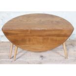 An Ercol blonde elm and beech occasional coffee table with drop leaf, length 61cm, min. depth 37cm &
