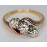 An 18ct gold three stone diamond ring, marked '18ct', gross wt. 3.66g, size N.