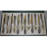 A cased set of 12 continental silver handle knives and forks, marked 800.