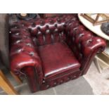 An oxblood leather Chesterfield armchair