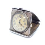 A silver purse or travel clock of fold out form, dial diam. 30mm, condition - appears in working
