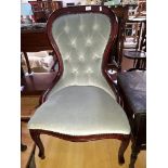 A reproduction continental style button back nursing chair