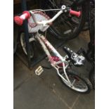 A child's white "Hello Kitty" bike