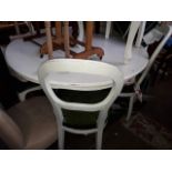 A white painted round table and 6 balloon back chairs