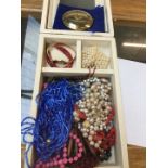A jewellery box containing mainly costume necklaces and some bangles