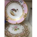 A 19th century porcelain plate decorated with a wading bird with pink and gilt border together