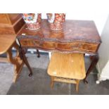 A walnut two drawer writing desk on cabriole legs