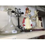 A ship's decanter, religious figure, metal candle holder, and another figurine