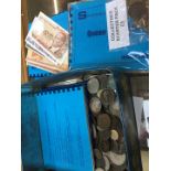 A box of world coins and banknotes.