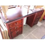 A reproduction mahogany pedestal desk