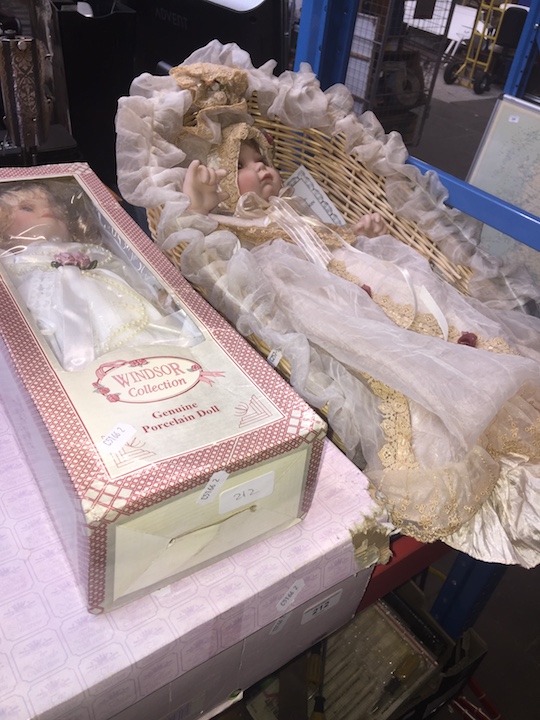 A bisque wedding doll in wicker basket and 2 boxed dolls