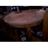 An oak oval extending wind out table - with winder