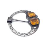 A Scottish Celtic style plaid pin brooch set with orangey yellow stones, diam. 47mm, marked '