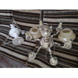 A brass effect ceiling light fitting, a pair of glass shades and a marble effect table lamp