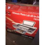 A Lexmar Ultimate Photo Lab All-in-One P6350 printer in box with accessories and instructions