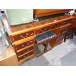 A reproduction yew wood pedestal writing desk