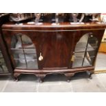 A bow front mahogany display cabinet with shell carving and cabriole legs, width 144cm, depth 44cm &