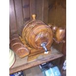 A wooden barrel drink dispenser on stand + 3 wooden beakers.