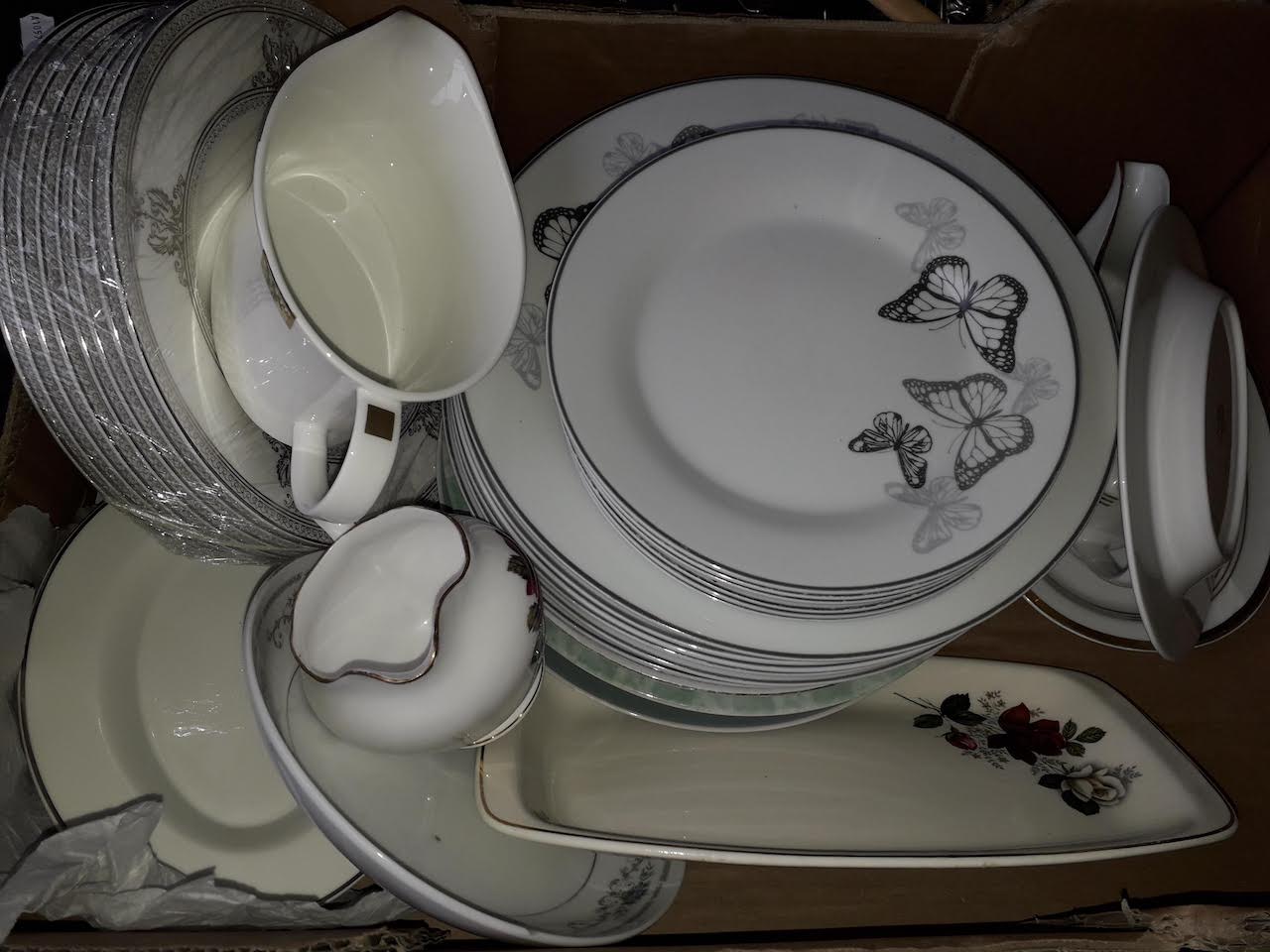 A box of mixed dinner ware