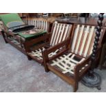 A three piece retro 1970s teak frame suite comprising daybed and pair of reclining armchairs, the