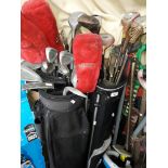 2 golf bags with quantity of golf clubs.