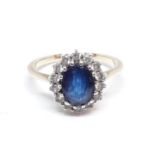 A diamond and sapphire ring, the central oval cut stone approx. 7mm x 5mm x 3mm, band unmarked,