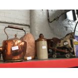 Vintage wooden carriage with horse, a stoneware bottle, a Himalayan salt lamp and a copper kettle.