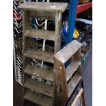 Two sets of wooden step ladders