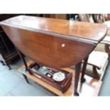 A Georgian mahogany pad foot drop leaf table of oval form.