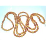 A single strand of butterscotch and translucent honey amber beads, approx. 8mm - 11mm each, gross