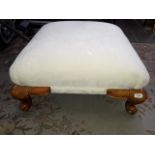 A cream upholstered footstool