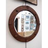 An oak framed round mirror