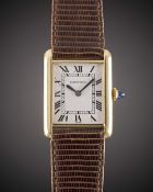 A GENTLEMAN'S SIZE 18K SOLID GOLD CARTIER TANK WRIST WATCH CIRCA 1980s Movement: Manual wind, signed