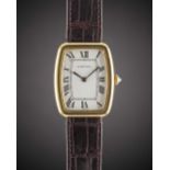 A GENTLEMAN'S SIZE 18K SOLID GOLD CARTIER PARIS "FABERGE TONNEAU" WRIST WATCH CIRCA 1980 Movement: